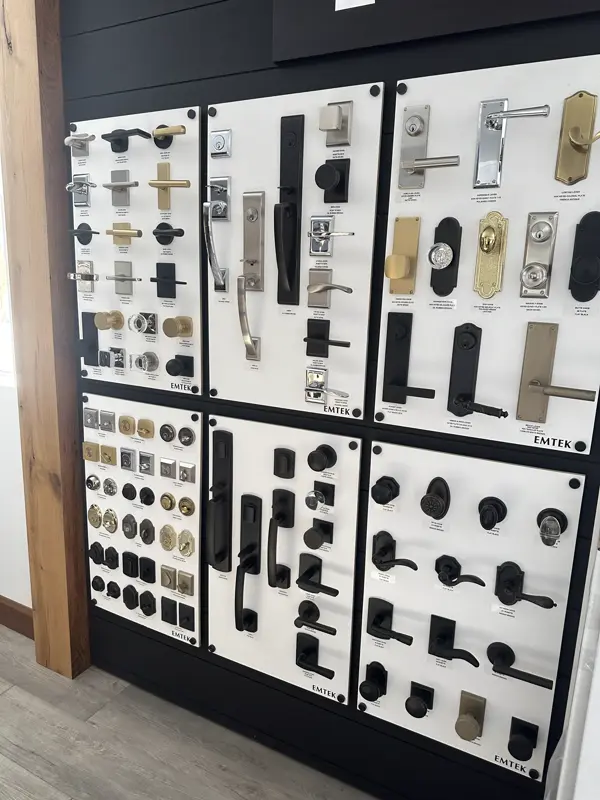 Emtek door hardware wall display with entry sets, levers and knobs in black, brass and nickel