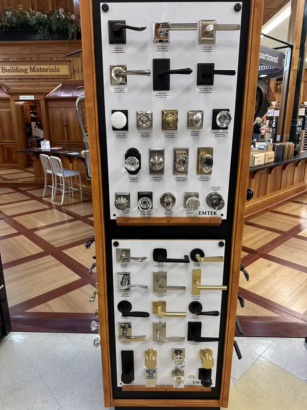 Emtek door hardware display in a wood frame at a building materials store